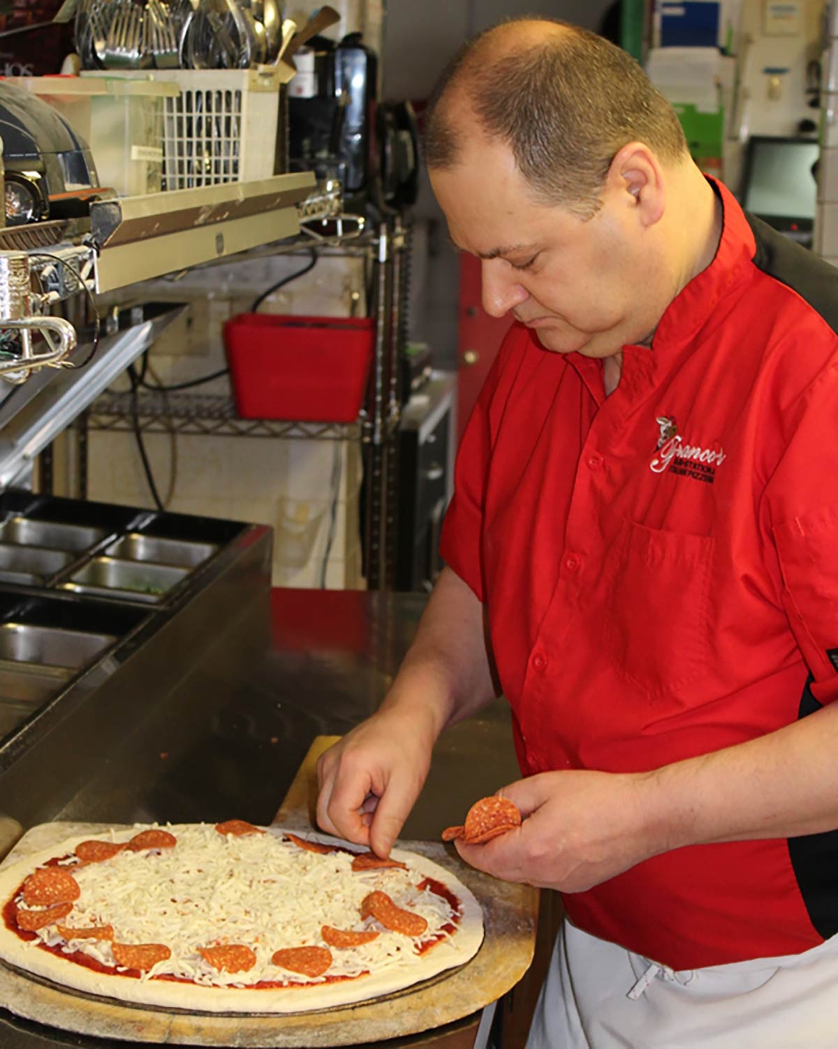 Franco making a pizza